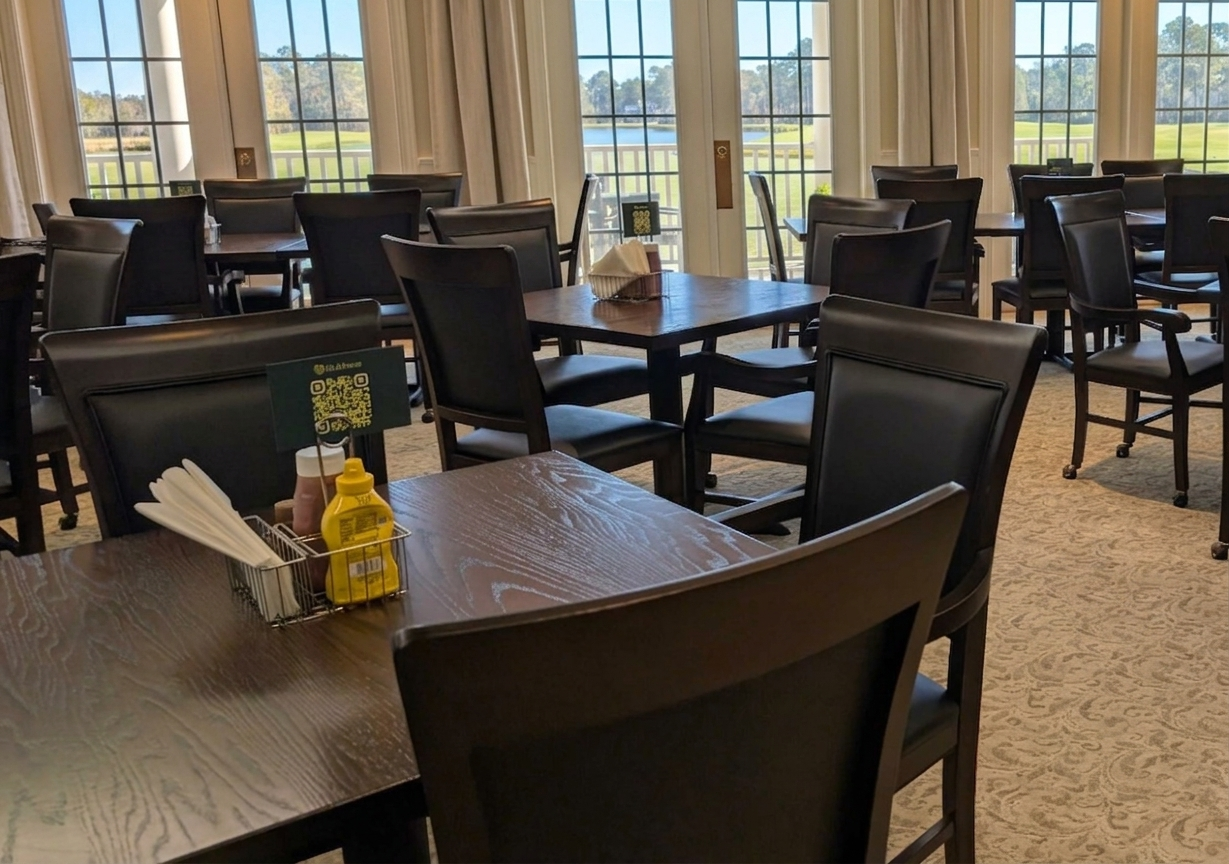 Clubhaus QR table tent on a dining table inside a clubhouse restaurant