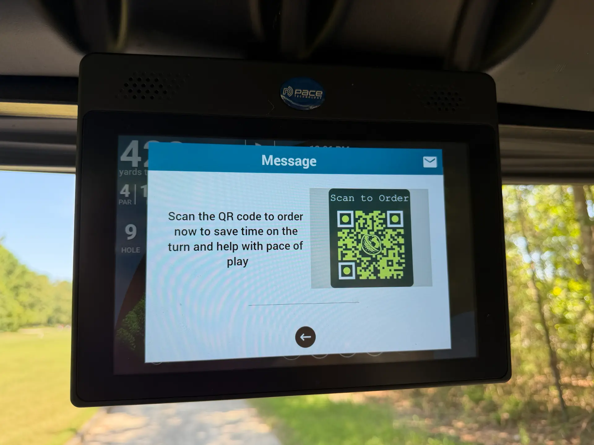 Golf cart GPS screen showing a Clubhaus scan-to-order QR code message